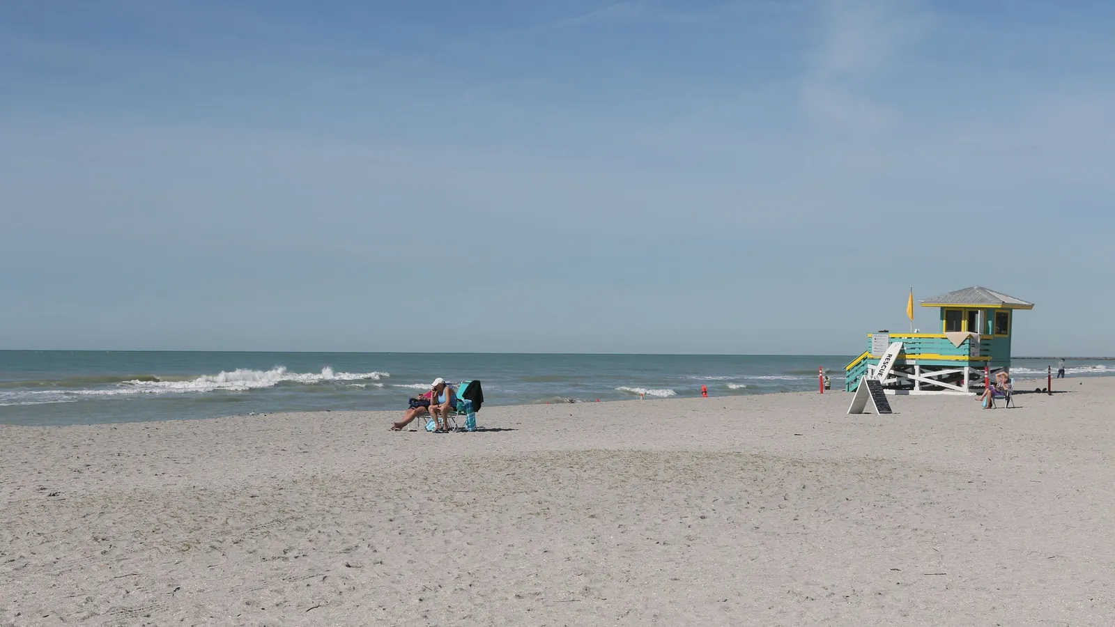 Quiet Florida beach with a lifeguard stand and calm surf