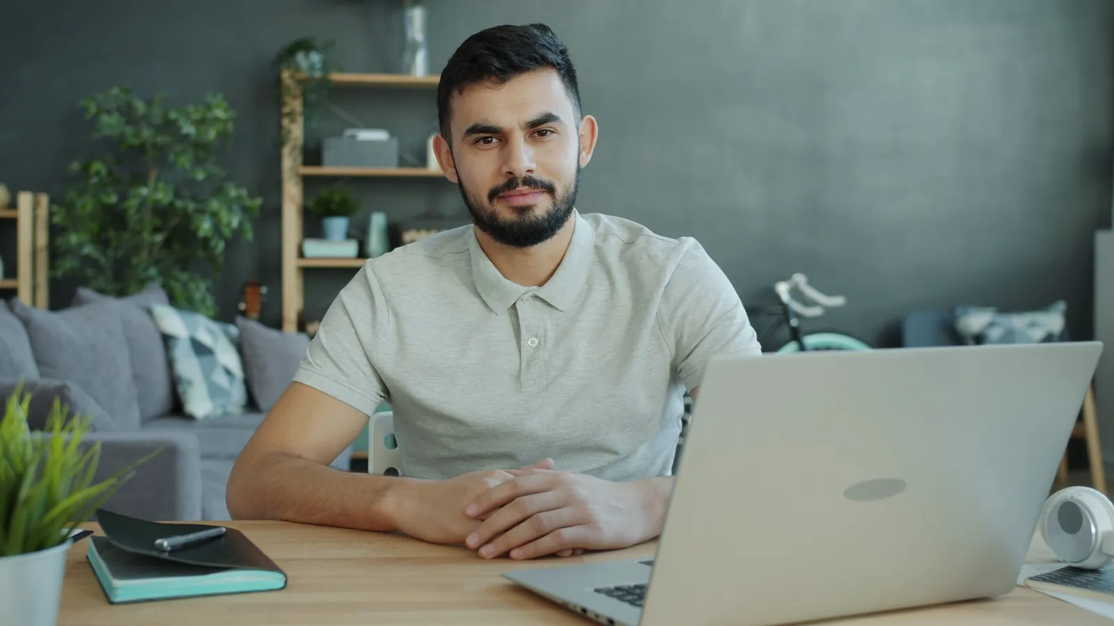 Self-employed man working on a laptop at a home office desk